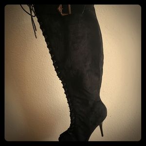 Black buckled thigh high heeled boots